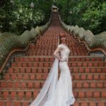 Tegan Marshall And The Wandering Wedding Dress At The Base Of The Stairs Of Buddhist Temple Chiang Mai Thailand