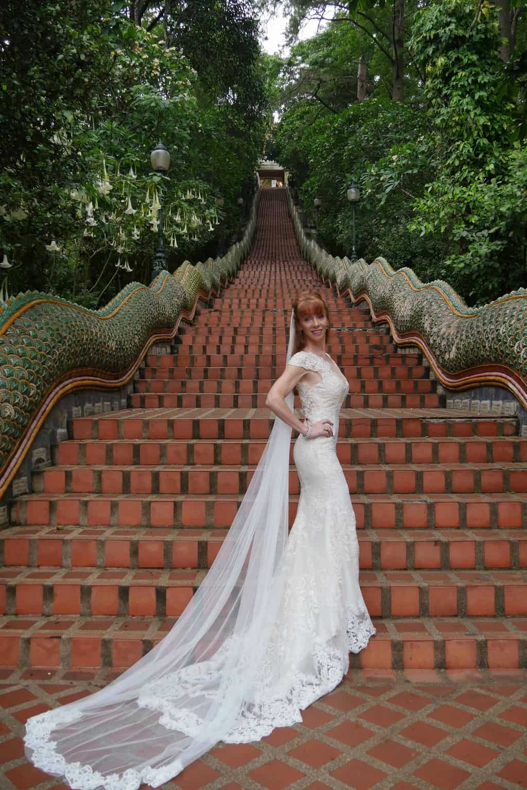 Tegan Marshall And The Wandering Wedding Dress At The Base Of The Stairs Of Buddhist Temple Chiang Mai Thailand