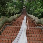Tegan Marshall In The Wandering Wedding Dress At The Base Of The Stairs At Buddhist Temple Thailand
