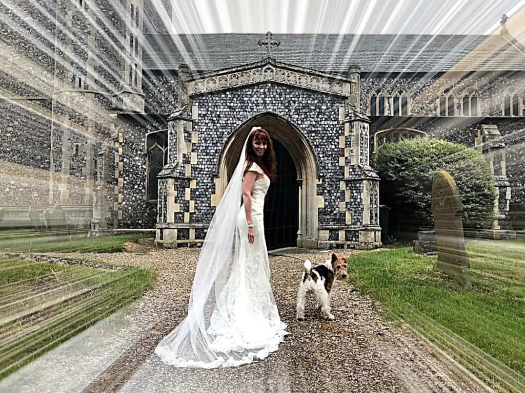 Tegan Marshall in the wandering wedding dress in England along with Pippin the fox terrier