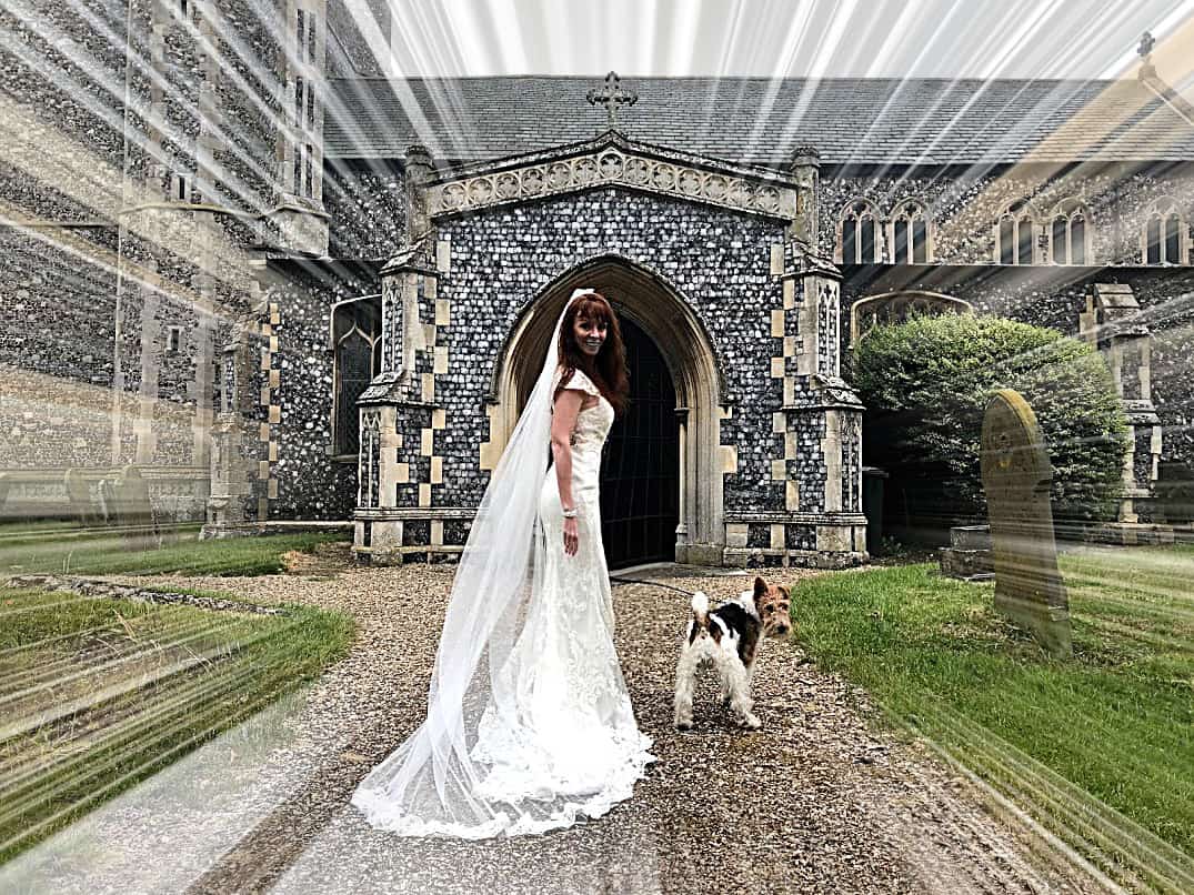Tegan Marshall in the wandering wedding dress in England along with Pippin the fox terrier