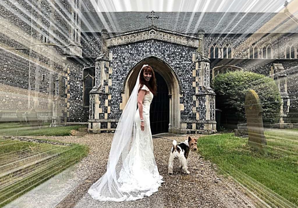 Tegan Marshall in the wandering wedding dress in England along with Pippin the fox terrier