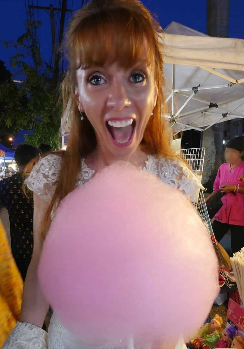 Tegan Marshall And Pink Cotton Candy At Chiang Mai Night Markets In Thailand Wearing Wandering Wedding Dress